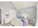 Cozy bedroom features a vaulted ceiling, arched window and comfy white bed with colorful pillows at 3162 Hazel Foster Dr, Carmel, IN 46033