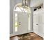 Inviting entryway features hardwood floors, a chandelier, and a door with sidelights for added light at 3162 Hazel Foster Dr, Carmel, IN 46033