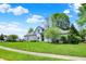 A well-maintained exterior of a suburban home with lush greenery and a spacious front yard at 3162 Hazel Foster Dr, Carmel, IN 46033