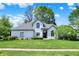 Charming front exterior with a lush green lawn and mature trees surrounding the property at 3162 Hazel Foster Dr, Carmel, IN 46033