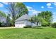 Well-manicured front yard with lush lawn and home exterior, featuring a three car garage at 3162 Hazel Foster Dr, Carmel, IN 46033