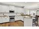 A well-equipped kitchen with stainless appliances, wooden floors, and white cabinets offers a modern design at 3162 Hazel Foster Dr, Carmel, IN 46033