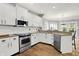 A modern kitchen features granite countertops, stainless steel appliances, and white cabinets at 3162 Hazel Foster Dr, Carmel, IN 46033