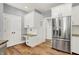 An updated kitchen with a stainless steel refrigerator, white cabinets, and wooden floors at 3162 Hazel Foster Dr, Carmel, IN 46033