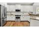 An open-concept kitchen features stainless steel appliances, granite counters, and white cabinetry at 3162 Hazel Foster Dr, Carmel, IN 46033