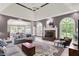 Bright living room featuring stylish sofas, a stone fireplace, and large windows offering scenic views at 3162 Hazel Foster Dr, Carmel, IN 46033