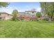 Two-story house featuring a large wooden deck, lush lawn, mature trees, and swing set at 320 Thornberry Dr, Carmel, IN 46032