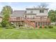 Expansive backyard featuring a spacious deck with stairs leading to a screened porch at 320 Thornberry Dr, Carmel, IN 46032