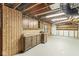 Spacious basement area with ample storage, wooden cabinets, and painted flooring at 320 Thornberry Dr, Carmel, IN 46032