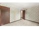 Cozy bedroom with floral wallpaper, neutral carpet and dark wood trim at 320 Thornberry Dr, Carmel, IN 46032