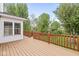 Large wooden deck with railings, back of the house, and green trees at 320 Thornberry Dr, Carmel, IN 46032