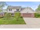 Charming two-story home with landscaped yard, brick accents, and a two-car garage at 320 Thornberry Dr, Carmel, IN 46032