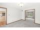 Bright living room with doorway to kitchen and windows creating an open, airy space at 320 Thornberry Dr, Carmel, IN 46032