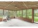 Sunroom with lattice ceiling, screened windows and views of the green backyard at 320 Thornberry Dr, Carmel, IN 46032
