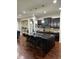 Spacious kitchen features a large island with seating and modern pendant lighting at 3243 Red Fox Trl, Columbus, IN 47201