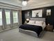 Beautiful bedroom boasts lots of natural light and tray ceiling with modern light fixture at 3243 Red Fox Trl, Columbus, IN 47201