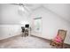 The attic has natural light, neutral-colored carpet, and a dedicated desk space at 329 W Hampton Dr, Indianapolis, IN 46208