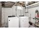 Basement laundry room featuring a modern washer and dryer with utility shelving nearby at 329 W Hampton Dr, Indianapolis, IN 46208