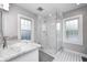 Modern bathroom featuring a glass-enclosed shower, granite vanity, and updated fixtures at 329 W Hampton Dr, Indianapolis, IN 46208