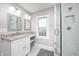 Bathroom featuring subway tile, vanity with a mirror, and glass enclosed shower at 329 W Hampton Dr, Indianapolis, IN 46208