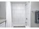 White subway tile, white bathtub, and a shower with chrome fixtures in a renovated bathroom at 329 W Hampton Dr, Indianapolis, IN 46208