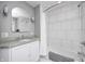 Bright bathroom featuring subway tile, granite vanity, and bathtub with shower at 329 W Hampton Dr, Indianapolis, IN 46208