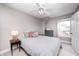 Bright bedroom with gray walls, ceiling fan, carpet, and a view from the window at 329 W Hampton Dr, Indianapolis, IN 46208