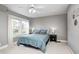 Comfortable bedroom with light gray walls, carpet, and a large window at 329 W Hampton Dr, Indianapolis, IN 46208