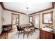 Elegant dining room with a wooden table, chandelier, and hardwood floors at 329 W Hampton Dr, Indianapolis, IN 46208