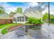 Charming home featuring a screened-in porch, mature landscaping, and a private driveway at 329 W Hampton Dr, Indianapolis, IN 46208