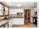 Functional kitchen with granite counters, stainless steel appliances, and white cabinets at 329 W Hampton Dr, Indianapolis, IN 46208