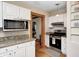 Efficient kitchen featuring granite countertops, stainless steel appliances, and white cabinets at 329 W Hampton Dr, Indianapolis, IN 46208