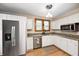 Well-lit kitchen with granite countertops, stainless steel appliances, and white cabinetry at 329 W Hampton Dr, Indianapolis, IN 46208