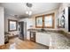 Charming kitchen with granite counters, stainless steel appliances, and hardwood floors at 329 W Hampton Dr, Indianapolis, IN 46208