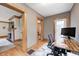 Bright, modern office space featuring hardwood floors, a wooden desk, and an adjacent living area with a fireplace at 329 W Hampton Dr, Indianapolis, IN 46208