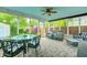 Cozy sunroom with lots of natural light, a ceiling fan, and comfortable wicker furniture at 329 W Hampton Dr, Indianapolis, IN 46208