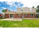 Brick home with a sliding glass door and a well-maintained green lawn under a blue sky at 3505 Autumn Ct, Columbus, IN 47203