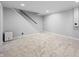 Finished basement area with carpeted floor and staircase to upper level of the home at 3505 Autumn Ct, Columbus, IN 47203