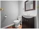 Half bath with vanity, toilet, mirror and hardwood floors at 3505 Autumn Ct, Columbus, IN 47203