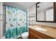 A cozy bathroom featuring a vibrant shower curtain, vanity and a mirror at 3505 Autumn Ct, Columbus, IN 47203