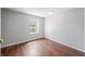 An inviting bedroom featuring natural light from the window and wood flooring at 3505 Autumn Ct, Columbus, IN 47203