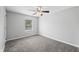 A bright bedroom featuring soft grey carpet and a ceiling fan for added comfort at 3505 Autumn Ct, Columbus, IN 47203