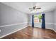 Calm bedroom with hardwood floors, gray walls, white trim, and natural light filtering in through the window at 3505 Autumn Ct, Columbus, IN 47203