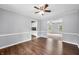 Inviting dining room with hardwood floors, neutral gray walls, white trim, and open access to other rooms at 3505 Autumn Ct, Columbus, IN 47203