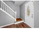 Entryway features hardwood floors, a white staircase, and a decorative front door at 3505 Autumn Ct, Columbus, IN 47203