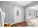 Bright foyer with hardwood floors, gray walls, and a white front door with an oval glass insert at 3505 Autumn Ct, Columbus, IN 47203