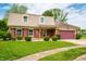 Inviting two-story brick home with tan siding and a lush green lawn, providing a welcoming curb appeal at 3505 Autumn Ct, Columbus, IN 47203