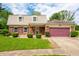 Attractive brick home with tan siding and a cozy covered porch, complemented by well-maintained landscaping at 3505 Autumn Ct, Columbus, IN 47203
