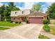 Charming two-story home with brick and vinyl siding, an attached garage, and a well-manicured lawn at 3505 Autumn Ct, Columbus, IN 47203