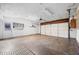 Spacious garage with an automatic garage door opener, side door, and bright lighting at 3505 Autumn Ct, Columbus, IN 47203
